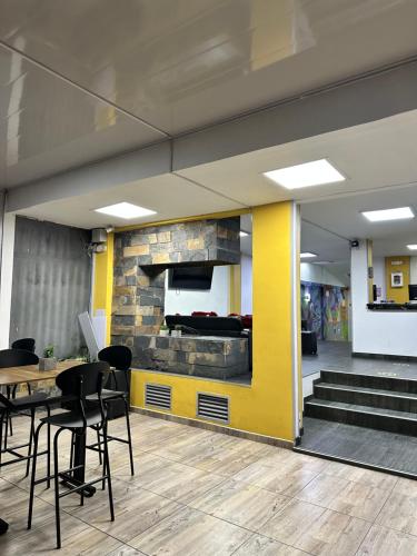 a room with a table and chairs and a fireplace at Hotel Bestmark Platino en Chapinero Bogota in Bogotá