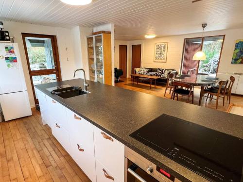 a kitchen with a counter top and a living room at 6 person holiday home in Asperup in Asperup