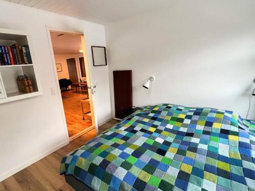a bedroom with a bed with a colorful blanket at 6 person holiday home in Asperup in Asperup