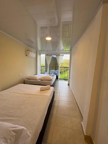 two beds in a room with a hallway at Sierra Serena Habitaciones in Santa Marta
