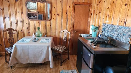 a kitchen with a sink and a table with a table and a sink at A Salter's Path in Beaufort
