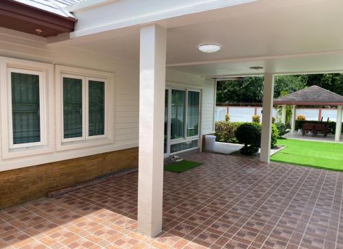 an empty porch of a home with a patio at Pool Villa in Thalang in Ban Na Nai