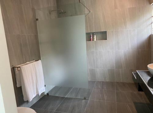 a bathroom with a shower with a toilet and a sink at Pool Villa in Thalang in Ban Na Nai