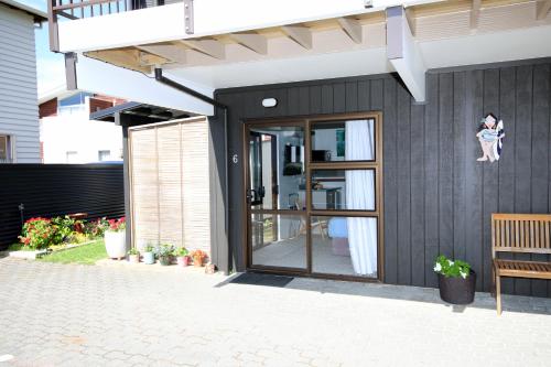 a house with a sliding glass door on a patio at Blue Marlin Apartments in Whitianga