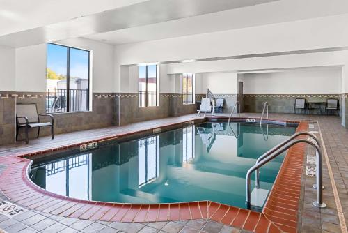 a large pool with blue water in a hotel room at Best Western St. Louis Airport North Hotel & Suites in Hazelwood