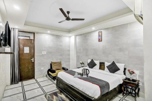 a bedroom with a bed and a ceiling fan at Collection O AP Grand in Noida