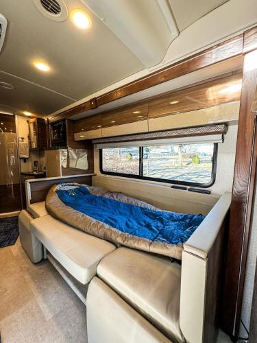 a bed in the back of an rv at Navi- HUGE yard- MEGA playset- CUTE RV in Willmar