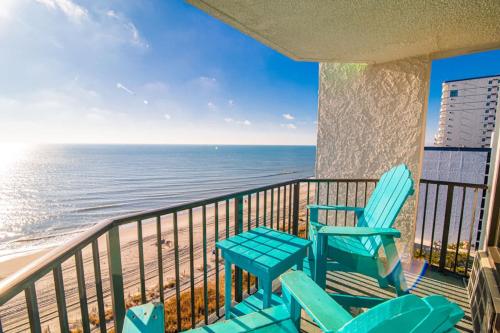 a balcony with two chairs and the ocean at Pet Friendly Modern Oceanfront Suite in Myrtle Beach