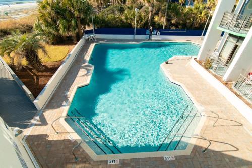 an overhead view of a swimming pool with blue water at Oceanfront Pet Friendly Modern Suite in Myrtle Beach