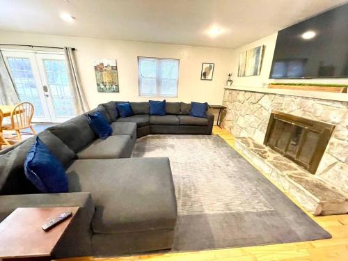 a living room with a couch and a fireplace at Large Private Ranch - Master Bedroom Suite with King Bed and private Bathroom - Fenced Yard - Pets & Kids Welcome - Pool Table in Columbus