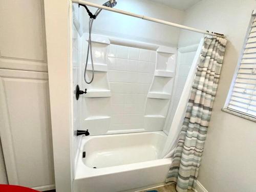 a bathroom with a shower and a white shower backdoor at Large Private Ranch - Master Bedroom Suite with King Bed and private Bathroom - Fenced Yard - Pets & Kids Welcome - Pool Table in Columbus