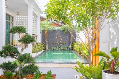 a swimming pool in the middle of a courtyard with trees at De Lunar Kohlarn in Ko Sak
