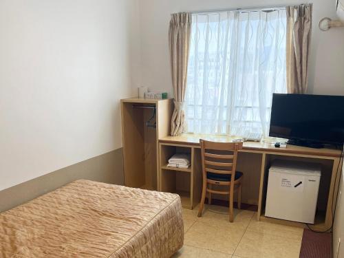a bedroom with a desk with a computer and a window at Hotel Yamadaso - Vacation STAY 10193v in Nago
