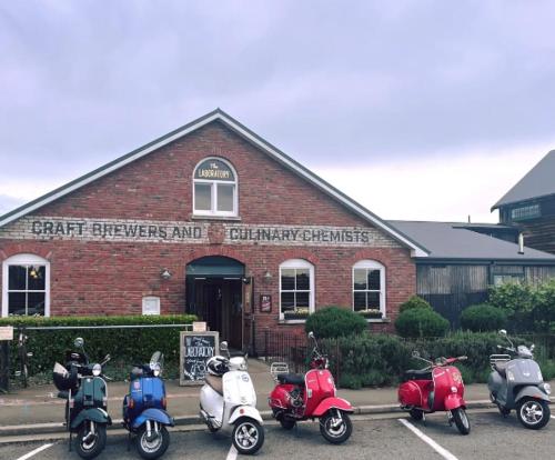 a group of scooters parked in front of a brick building at Willow Tree Cottage in Lincoln