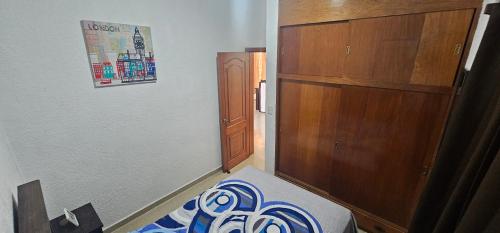 a bedroom with a bed and a wooden cabinet at Lu'um Balún Canán in Comitán de Domínguez