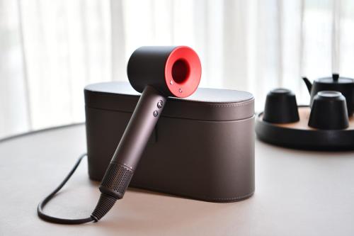 a hair dryer sitting on top of a black holder at JOYA Shanghai Gubei in Shanghai