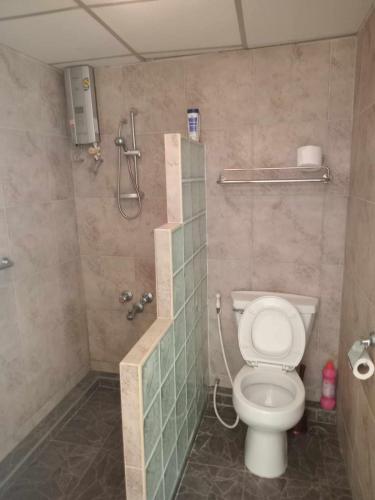 a bathroom with a toilet and a shower stall at Vip Condo Rayong beach in Rayong