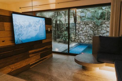Télévision ou salle de divertissement dans l'établissement Kuun Taak Tulum