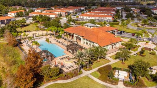 an aerial view of a house with a swimming pool at LAKE VILLA 6bd, all un-suite, pool, spa, grill in Kissimmee