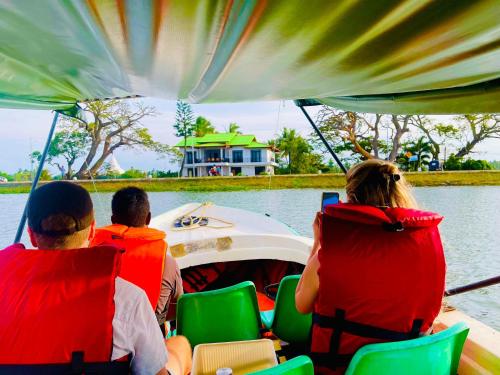 a group of people sitting on a boat on the water at Tissa Yala Lake View Hotel in Tissamaharama