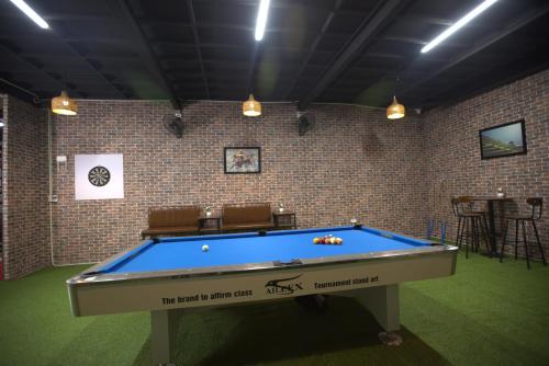 a billiard room with a blue pool table at Moc May by Northstar Hostel & Tours in Ha Giang