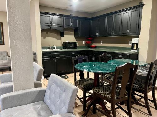 a kitchen with a table and chairs in a room at Country Hearth Inn & Suites Augusta in Augusta