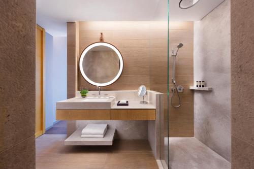 a bathroom with a sink and a mirror at Andaz Singapore, By Hyatt in Singapore