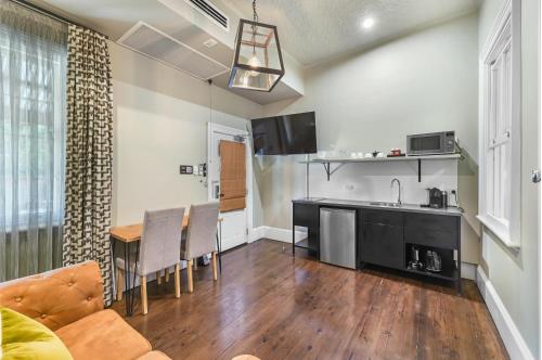 a kitchen and living room with a couch and a table at The Houston Boutique Hotel Wagga in Wagga Wagga