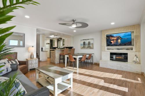 a living room with a table and a fireplace at Beachfront Getaway with Ocean Views and Private Patio in Newport Beach