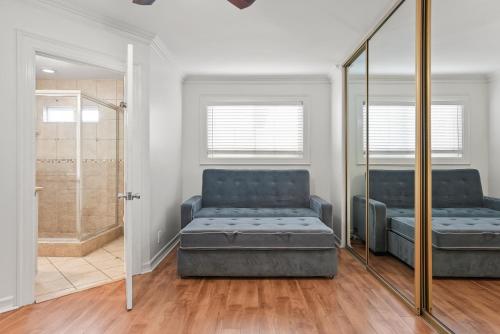 a waiting room with a couch and a mirror at Beachfront Getaway with Ocean Views and Private Patio in Newport Beach