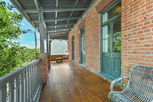 a porch with a bench on a brick building at The Houston Boutique Hotel Wagga in Wagga Wagga