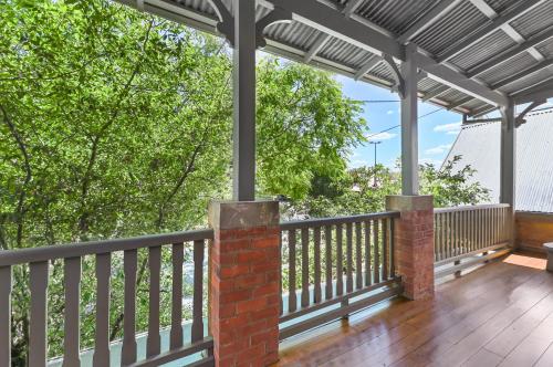 a porch with awnings and a wooden deck at The Houston Boutique Hotel Wagga in Wagga Wagga