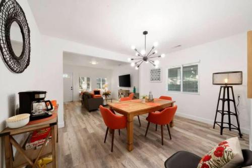 a dining room and living room with a table and chairs at Central 2BR 1BA & Arcade Crib in the heart of Sac in Sacramento