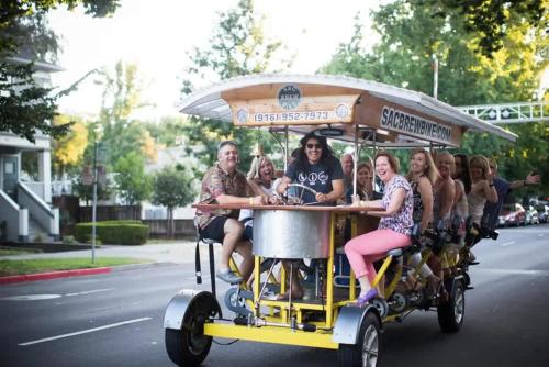 a group of people riding on a food cart at Central 2BR 1BA & Arcade Crib in the heart of Sac in Sacramento