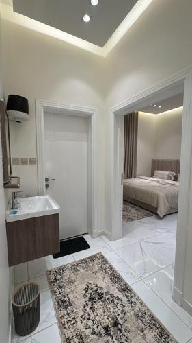 a bathroom with a sink and a bed at Relax in Buraydah