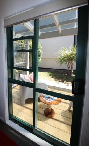 a view of a porch from a window of a house at Blue Marlin Apartments in Whitianga