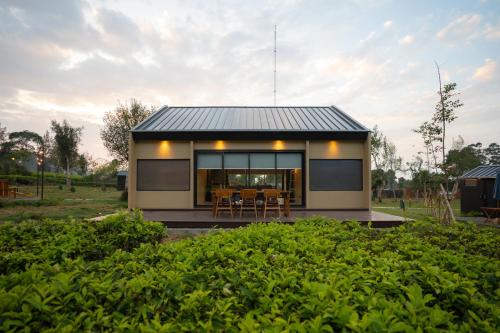 a small house with a black roof at Bobocabin Pangalengan, Bandung in Pengalengan