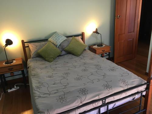 a bed in a room with two lamps and two tables at Lara Hobby Horse Centre of Excellence in Lara