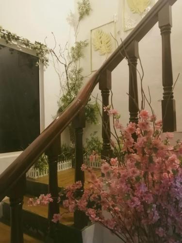 a stairway with a bunch of flowers at Homestay Murah Lahad Datu in Lahad Datu