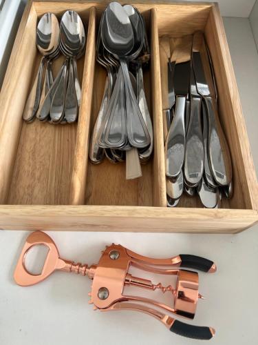 a drawer filled with utensils and a wooden box at Casa d lujo e Xcaret in Playa del Carmen