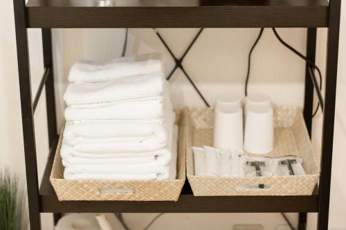 a shelf with towels and toilet paper on it at Osaka Condo walk to Shinsaibashi 8ppl 501&502 in Osaka