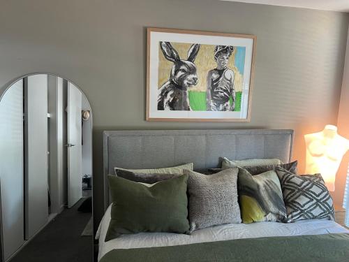 a bedroom with a bed with a picture on the wall at Albert Park Haven in Melbourne