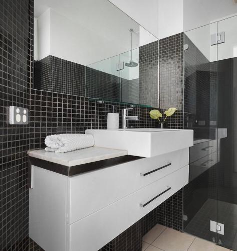 a bathroom with a white sink and a mirror at Albert Park Haven in Melbourne