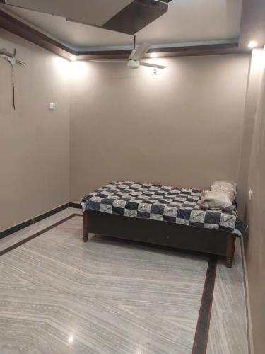 a bedroom with a bed in the corner of a room at Rock well in Prayagraj