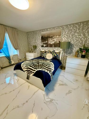 a bedroom with a zebra bed in a marble floor at Country Haven Comfy & Sleek House in Monasterevin