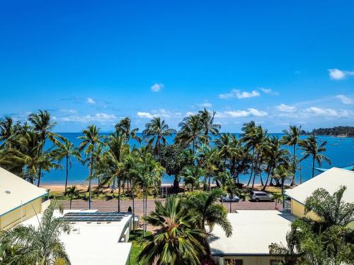 an aerial view of a resort with palm trees and the ocean at Sails On Horseshoe in Horseshoe Bay
