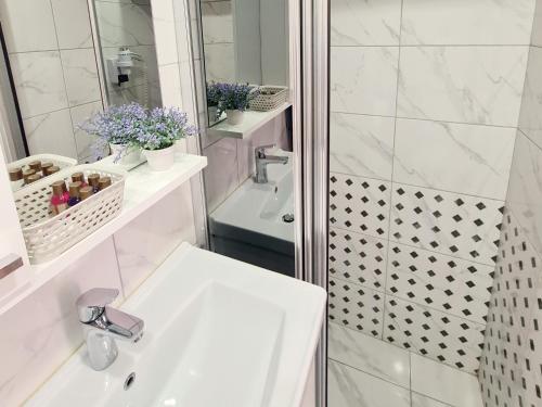 a white bathroom with a shower and a sink at SOFIA BOUTIQUE HOTEL in Kérynia