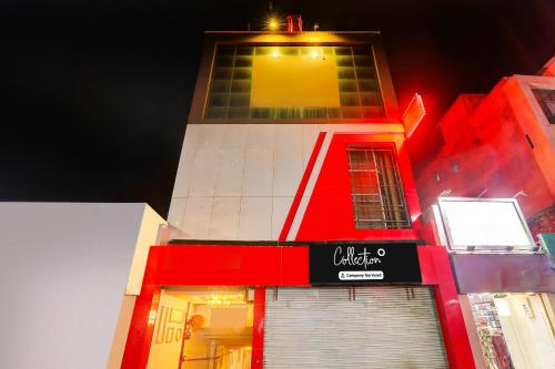 a tall red and white building with a sign on it at Super Collection O Alambagh Formerly BM Palace in Lucknow