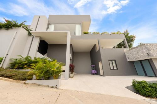 a large white house with a driveway at Green Lotus Samui in Ban Bang Po