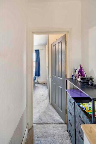 a kitchen with a door leading into a room at Private Room in Uxbridge near Heathrow in Uxbridge